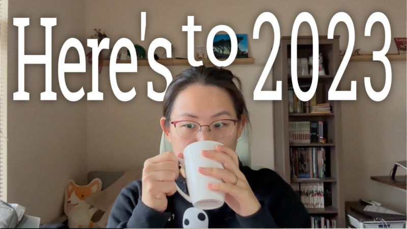 Here's to 2023 - Theresa sits at her computer desk drinking out of a white mug.